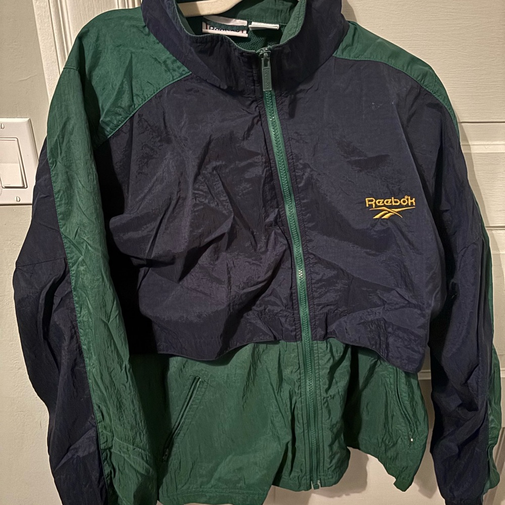 Vintage Reebok Blue and Green windbreaker 90s, with a buttoned up hood option